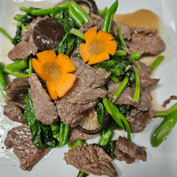 Erawan's Thai beef stir-fry with green vegetables, mushrooms, and flower-cut carrots.