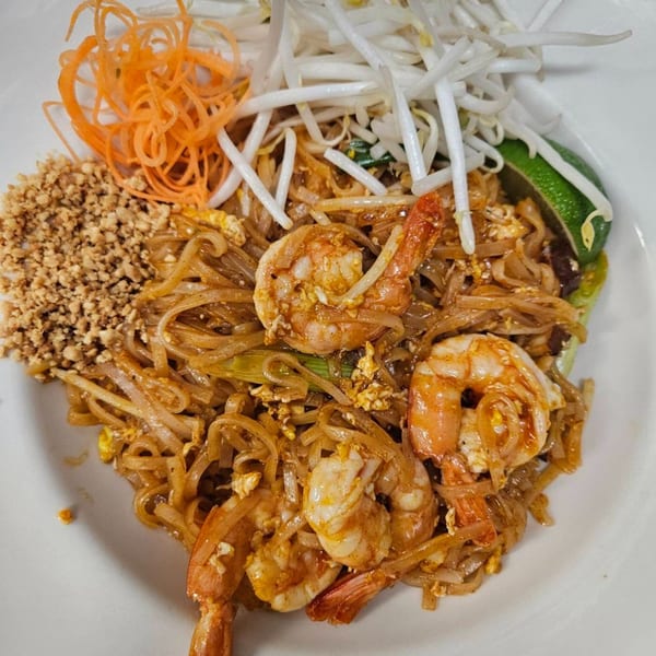 Erawan's Pad Thai with shrimp, bean sprouts, shredded carrots, crushed peanuts, and lime.