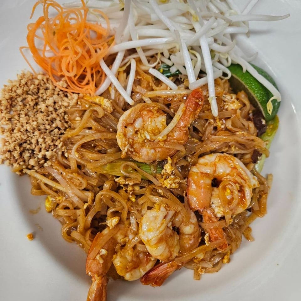 Erawan's Pad Thai with shrimp, bean sprouts, shredded carrots, crushed peanuts, and lime.